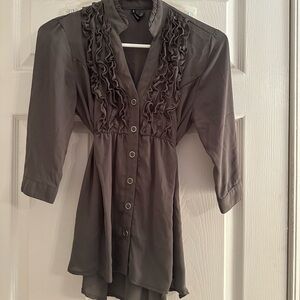 Button up in front and has a tie in the back. Sheer like material